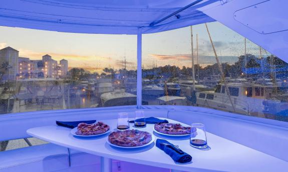Food and drink for two on a table aboard a power yacht, at dock in St. Augustine