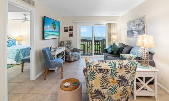The main room of a condo, looking toward the balcony off the living room