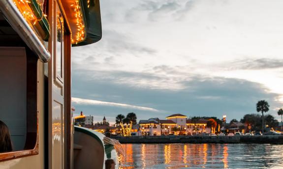 A view aboard the tiny tug, "Lady Augustine," looking toward the lights of the city