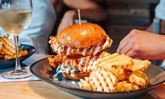 A buffalo chicken sandwich and a side of fries