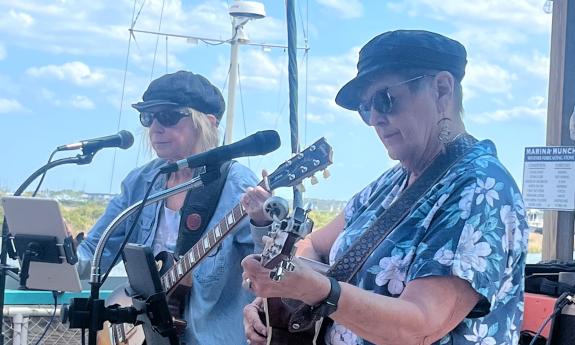 Sandi Dotson-Kirn and She Fay performing at a marina