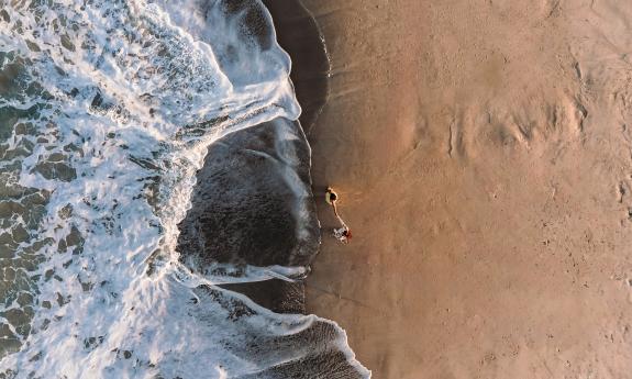 A drone shot of a couple at the beach