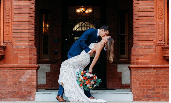 A bride and groom kissing at Flagler College