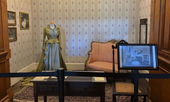 An exhibit of clothing and decor at Flagler College