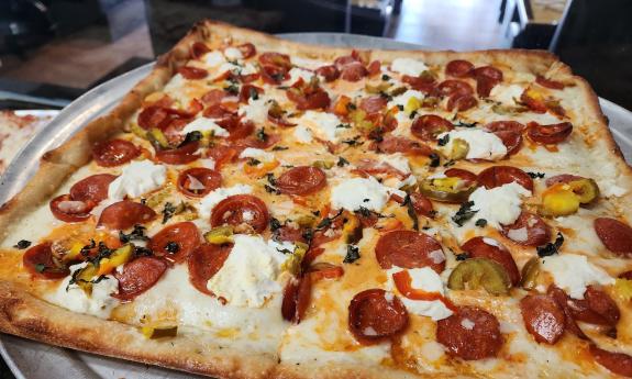 Romano's square pizza with added cheese and meat