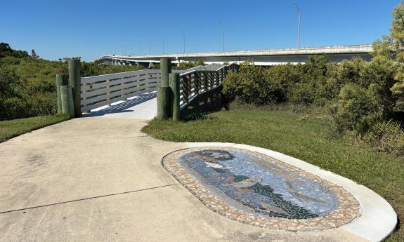 A mosaic on the ground near the entrance