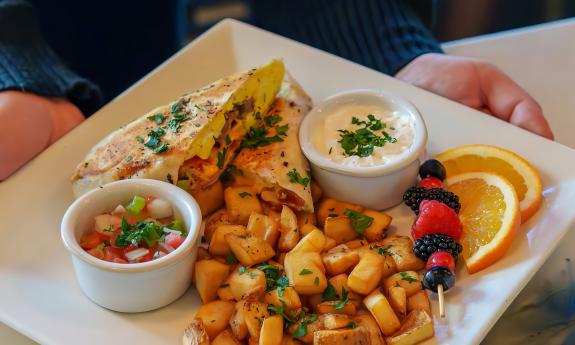 A breakfast burrito, salsa, and fried potatoes offered at Voco hotel on Anastasia Island