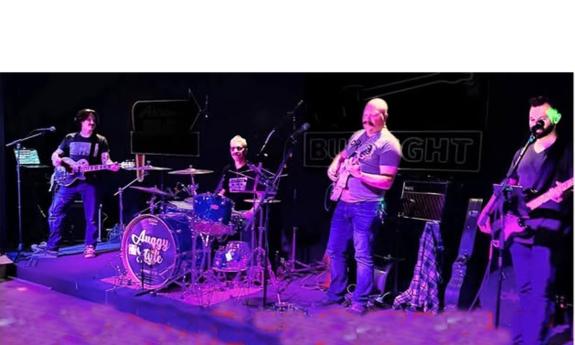 The band Auggy Style, onstage, playing