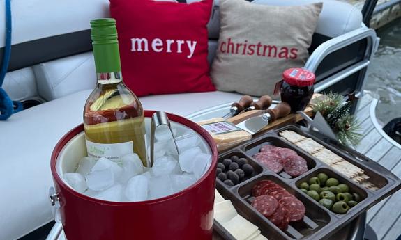 Wine in a bucket of ice and a charcuterie board for a Nights of Lights cruise