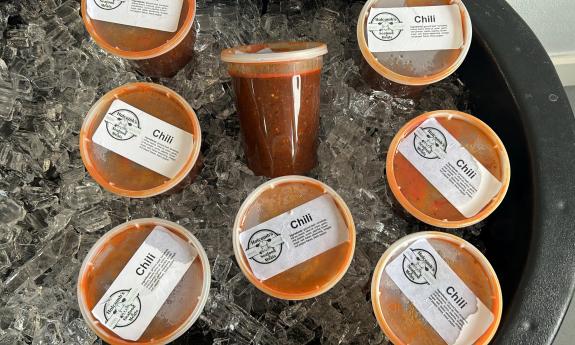 Packaged chili soup in a bed of ice