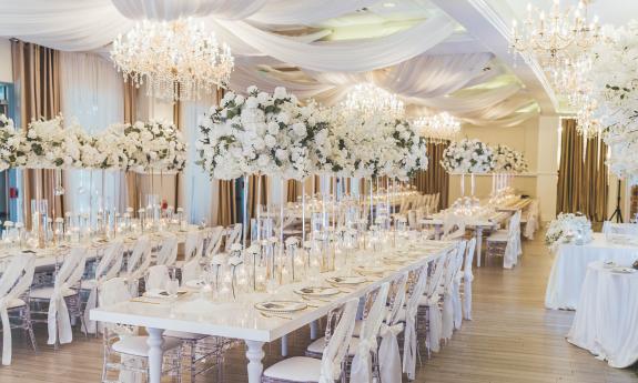 Tables arranged for a wedding with a white decor
