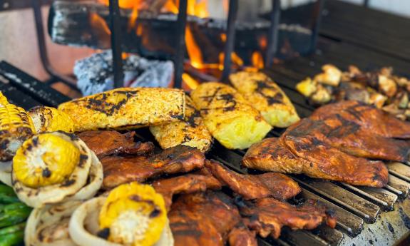 Food placed on the pecan-fired asado grill