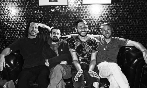 Members of Spafford sitting on a sofa
