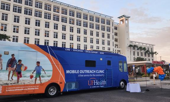 The UF Care bus and race table at Flagler Hospital for the 5K