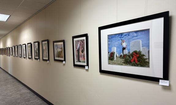 A wall of photographs down a long hallway