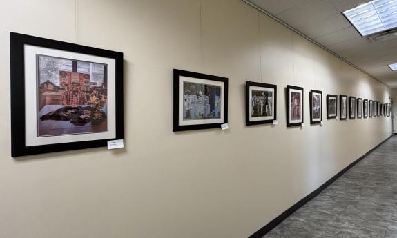 A wall of photographs down a long hallway
