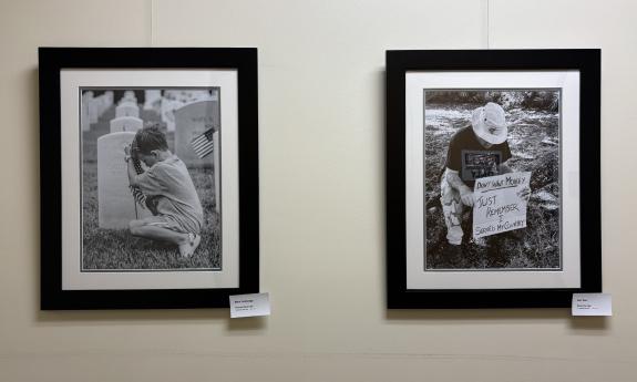 Two photographs, framed in black, in an exhibit honoring U.S. veterans
