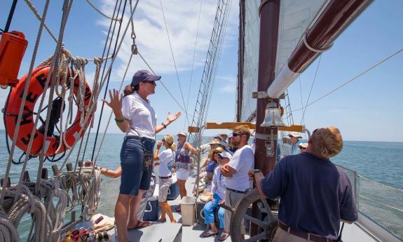 A guide teaching aboard a boat