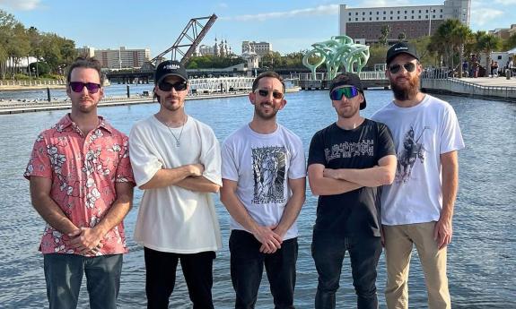 The band Ajeva standing by the waterside