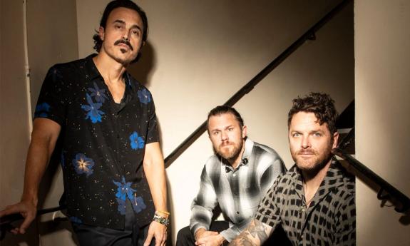 Bandmates from The Fray pose on a staircase.