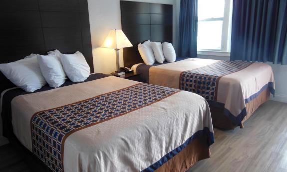 Two full beds in one of the motel suites