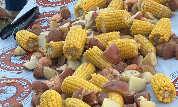 Corn, potatoes, shrimp, and sausage, on a table ready for serving