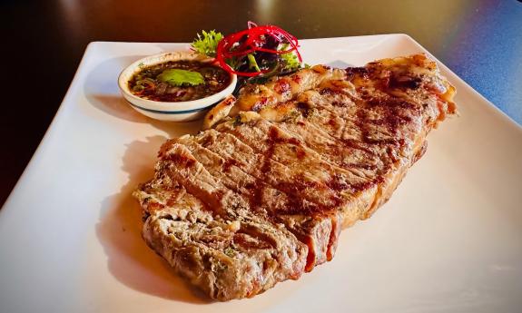 A plate with tender beef and garnishes