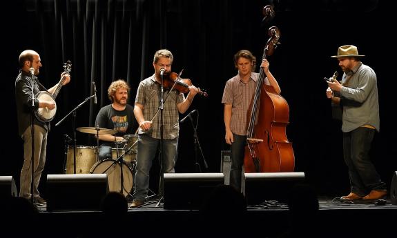The Wild Shiners on stage in front of a black curtain
