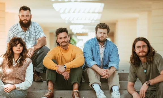 the band Dawson Hollow sitting together, all smiling