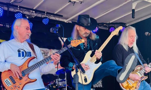 three guirtarists of Those Guys on stage, playing 