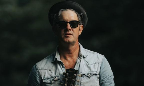 G Love poses with his guitar.