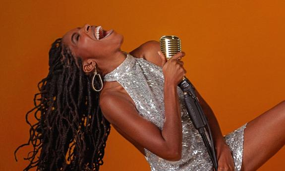 Singer songwriter KEBA singing with a microphone