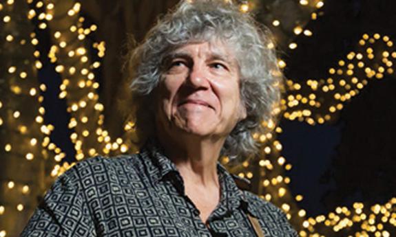 songwriter novelist Rod MacDonald on stage at night, smiling