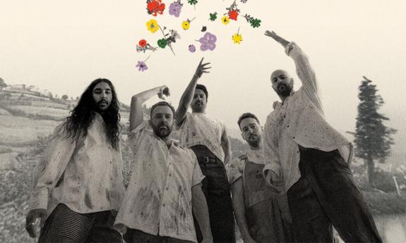 Bandmates from Young The Giant throw colorful flowers in the air.