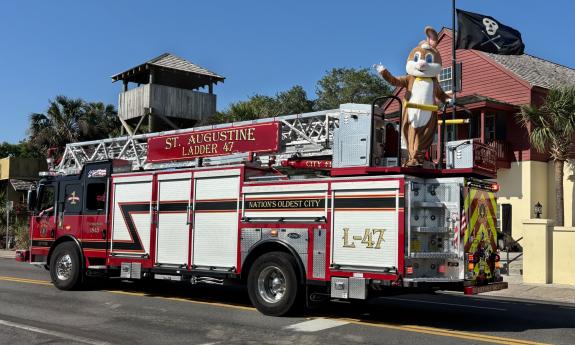 The Easter Bunny waving from a firetruck