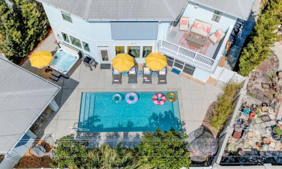 A large vacation rental with pool house, as seen from above