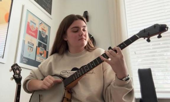 Banjo artist Paige Bechtold playing in her studio