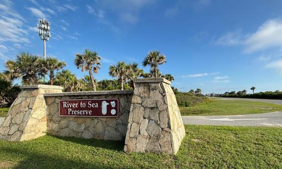 The stone pillars and sign for the River to the Sea Preserve