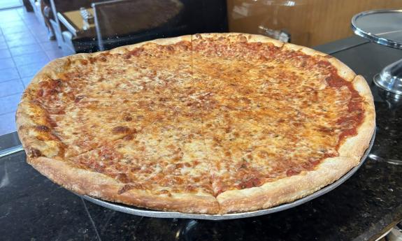 A whole pan of a cheese pizza