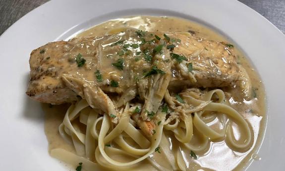 Salmon on top of a bed of pasta