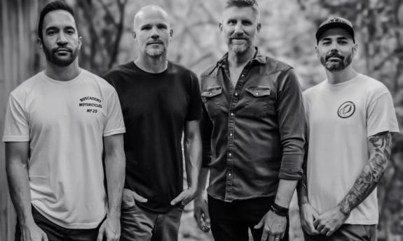 Bandmates from Exhaustra pose in a black and white photograph.