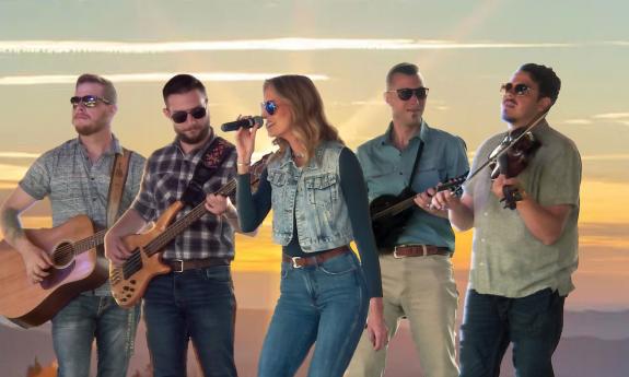 Monroeville band with instruments, sky in background