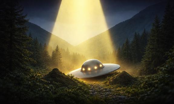 A small spaceship, lit from above, nestled in a valley