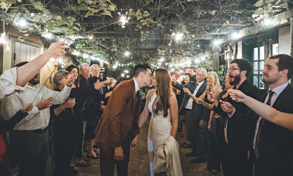 The bride and groom with sparklers held by the guests