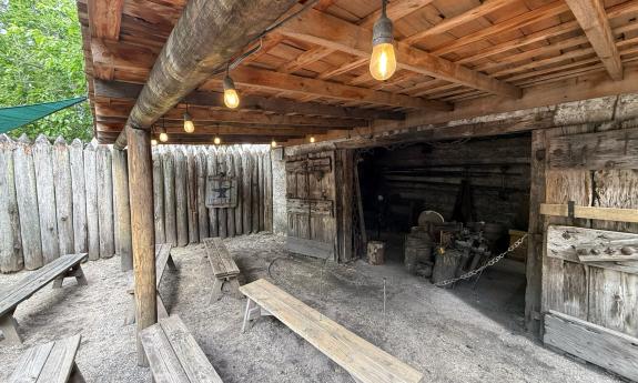 The blacksmith shop in Colonial Quarter has benches to sit on