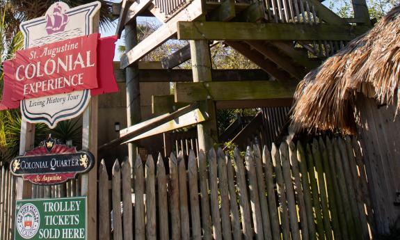 The sign between the street and the tower at the entry to Colonial Quarter in St. Augustine