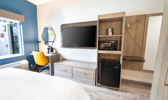 A view of the built-in-furniture at the foot of the bed in a hotel