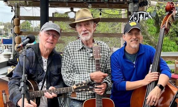 Thick & Thin String Band at a show, outside with instruments