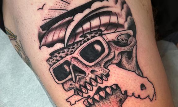A black and grey skull ink work