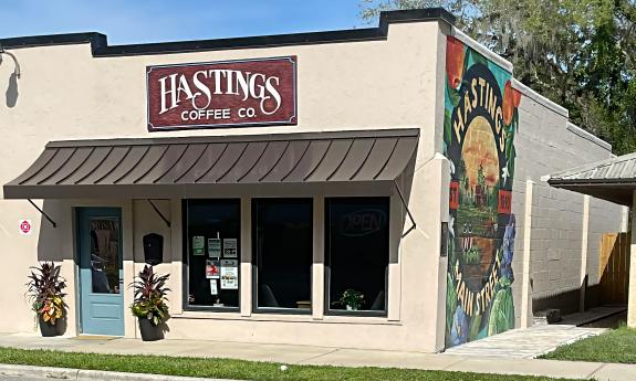 The exterior of Hastings Coffee Co. has a painted mural celebrating Main Street